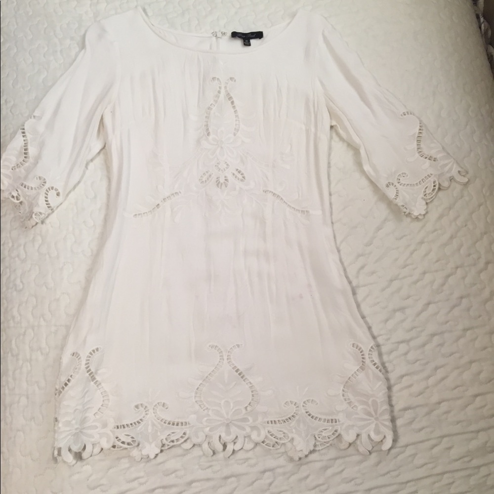 Beautiful white dress with lots of detailing.